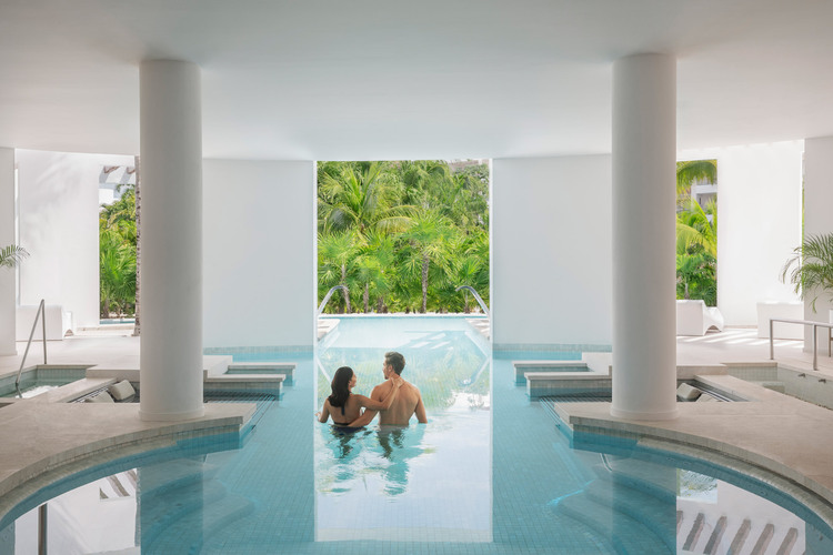 Couple enjoying the relaxing hdrotherapy of a beautiful spa in Excellence Playa Mujeres.